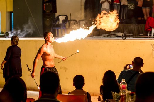 Spectacular show at an outdoor stage in Hammamet, Tunisia, where Local talent showcase their extraordinary ability to breathe fire like the mystical fire breathing dragons.