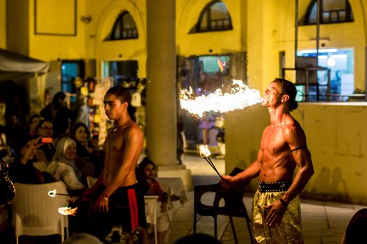 Spectacular show at an outdoor stage in Hammamet, Tunisia, where Local talent showcase their extraordinary ability to breathe fire like the mystical fire breathing dragons.