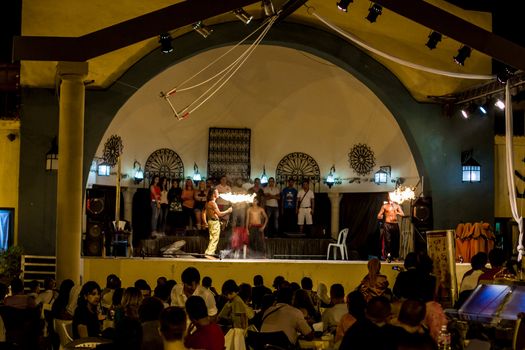 Spectacular show at an outdoor stage in Hammamet, Tunisia, where Local talent showcase their extraordinary ability to breathe fire like the mystical fire breathing dragons.