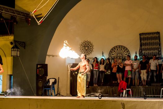 Spectacular show at an outdoor stage in Hammamet, Tunisia, where Local talent showcase their extraordinary ability to breathe fire like the mystical fire breathing dragons.