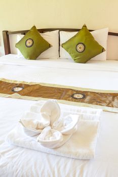 Hotel room in a tropical resort with bed and wooden flooring