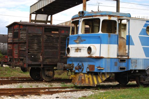 Old abandoned railway wooden wagon and vintage rail-motor