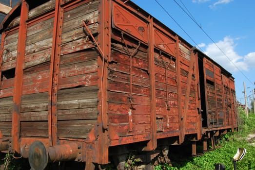 Old abandoned wooden brown red wagon close-up