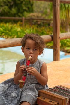 Cute girl in a  park playing with vintage instruments