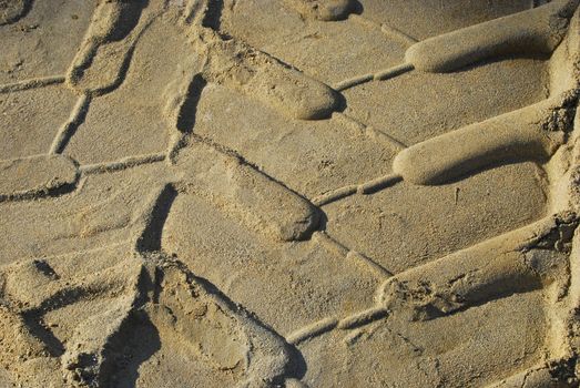 Heavy-duty tyre sand print close-up as background