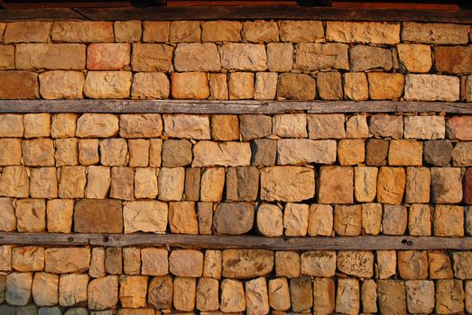 Old country yard dry masonry stonewall wooden beams as background