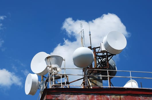 Mountain peak antennas and communication equipment on blue-sky background