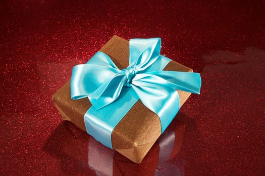 brown gift box on red sparkling background