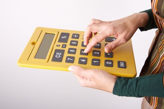 woman detail with a yellow big calculator in her hands