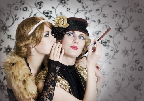 Two retro styled women sharing secrets on glamourous background