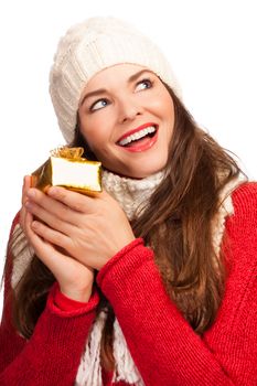 A beautiful happy young woman holding a small Christmas gift. Isolated on white.