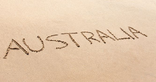 Australia written in the sand on a beautiful beach.