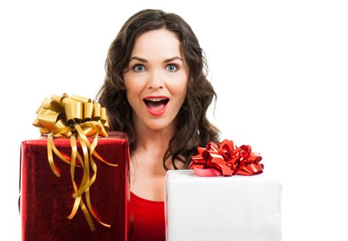 A beautiful surprised happy woman holding two Christmas gifts. Isolated on white.