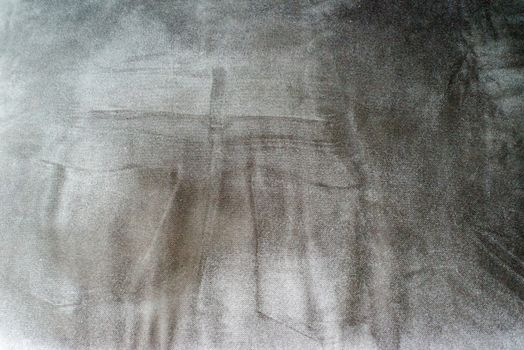 Abstract: Imprint of someone in jeans sitting on a dark gray sofa