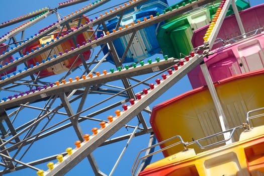 Brightly colored Ferris wheel against the blue sky