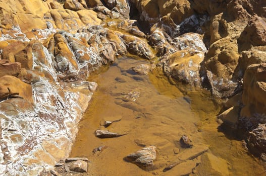 Detail of polluted riverbed of Mosteirao, downstream abandoned pyrite mine of S. Domingos , Mertola, Portugal