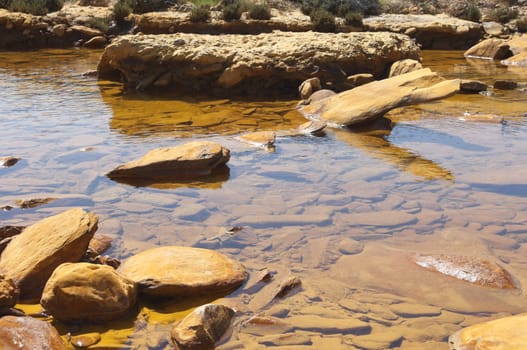 Detail of polluted riverbed of Mosteirao, downstream abandoned pyrite mine of S. Domingos , Mertola, Portugal