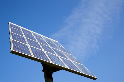 solar panel and blue sky with clouds that look like steam