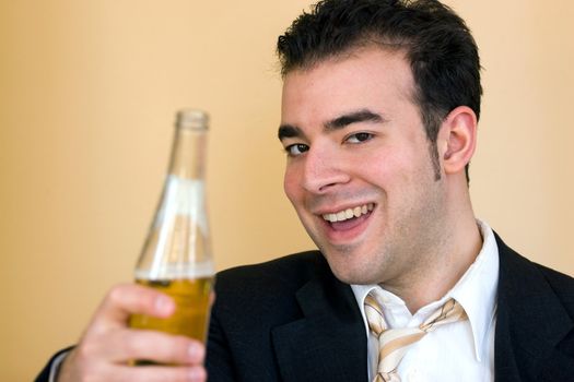 A young business man offering a beer after hours. Benjamin Franklin said that Beer is living proof that God loves us and wants us to be happy. 