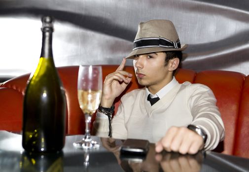Attractive man drinking in cocktail party at night club