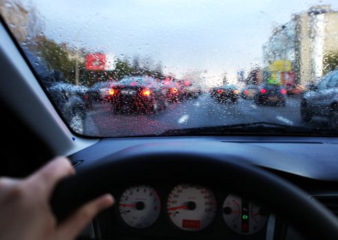 dashboard of car and rain drops on windshield