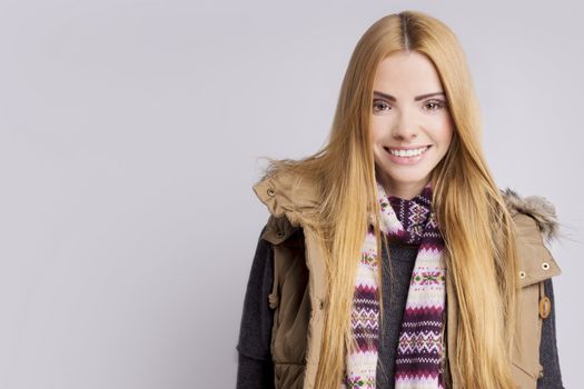 Young smiling woman wearing warm clothes