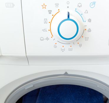 Open washing machine with control panel dial