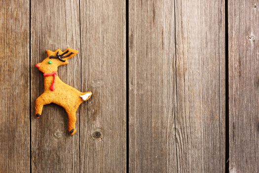 Christmas homemade gingerbread deer over wooden table