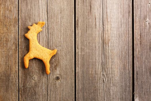 Christmas homemade gingerbread deer over wooden table