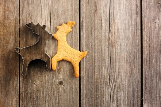 Christmas homemade gingerbread deer over wooden table