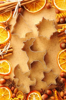 Christmas spices and cookie cutters over homemade gingerbread dough