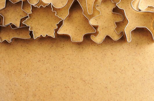 Christmas cookie cutters over homemade gingerbread dough