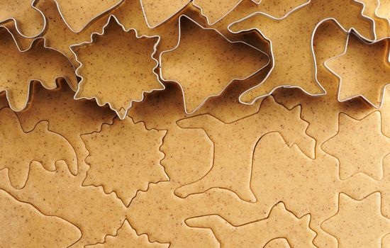 Christmas cookie cutters over homemade gingerbread dough