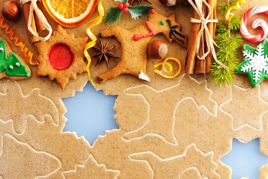 Christmas spices and cookies over homemade gingerbread dough