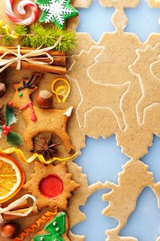 Christmas spices and cookies over homemade gingerbread dough