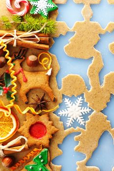 Christmas spices and cookies over homemade gingerbread dough