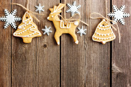 Christmas homemade gingerbread cookies over wooden table