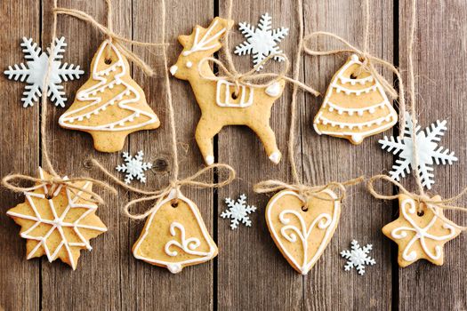 Christmas homemade gingerbread cookies over wooden table