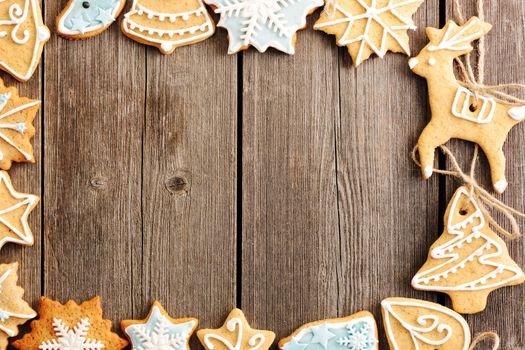 Christmas homemade gingerbread cookies over wooden table