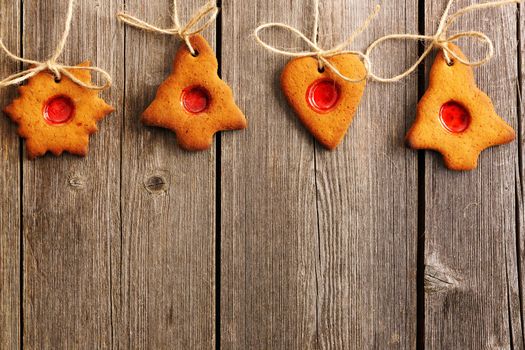 Christmas homemade gingerbread cookies over wooden table