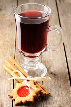 Glass of red mulled wine on wooden table