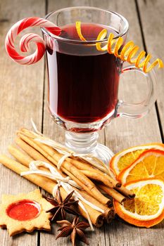 Glass of red mulled wine on wooden table