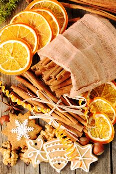 Christmas homemade gingerbread cookie and spices over wooden table
