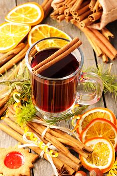 Glass of red mulled wine on wooden table