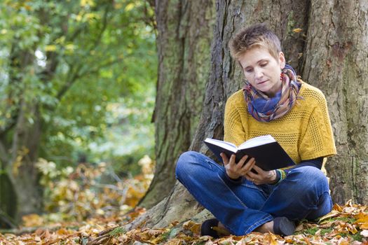 Woman reading book in the park 