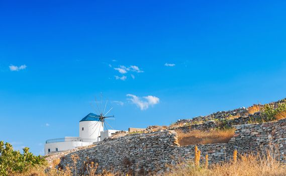 Windmill in Sifnos island, Greece, in rural setting. Space for text