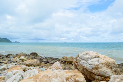 The rocks along the shoreline on the beach