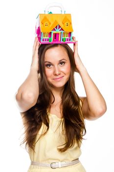 Young and beautiful woman with a toy in the hands of the house