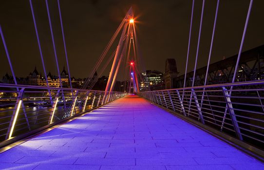 The modern Golden Jubilee Footbridge which crosses the River Thames in London.