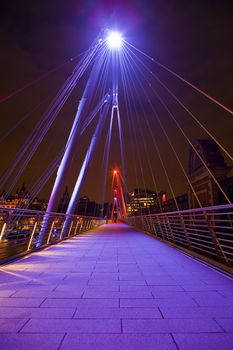 The modern Golden Jubilee Footbridge which crosses the River Thames in London.